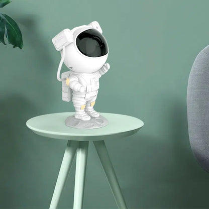astronaut galaxy projector standing on a green desk and leaf in the background